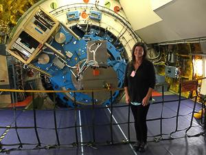 Dr. Smith inside SOFIA, showing the part of the telescope that extends into the main cabin.